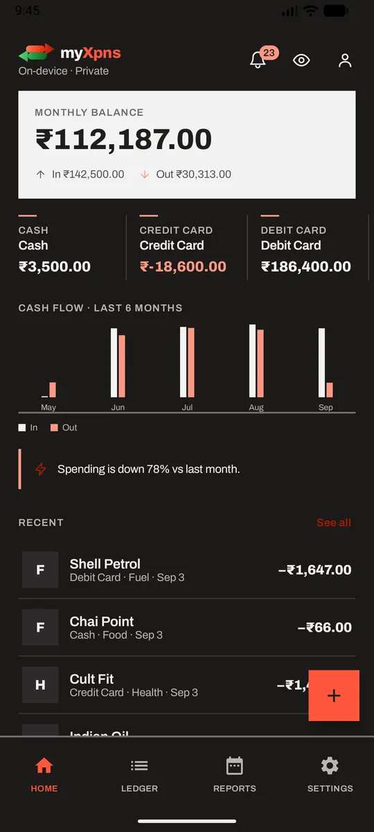The home screen in dark mode: a light balance card on a near-black ground, with the cash-flow chart in white and coral.